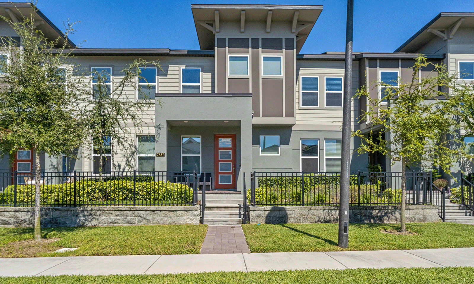 front of townhome with modern design and metal fence